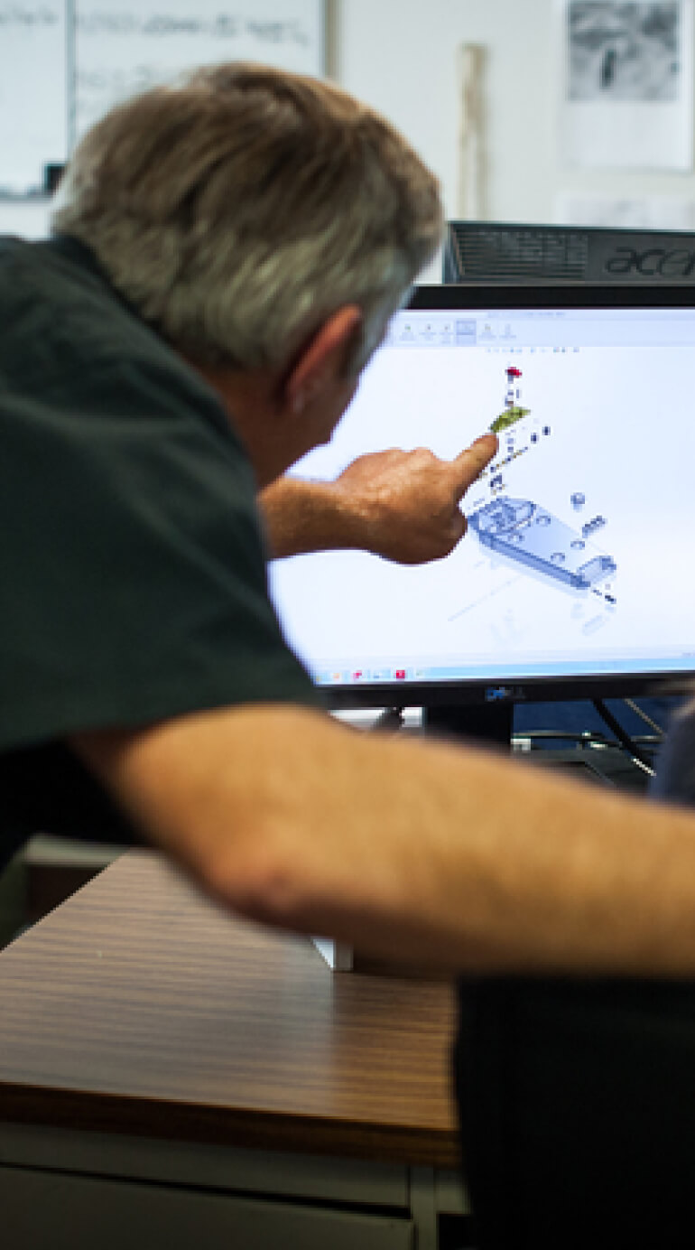 Employee pointing at a computer screen