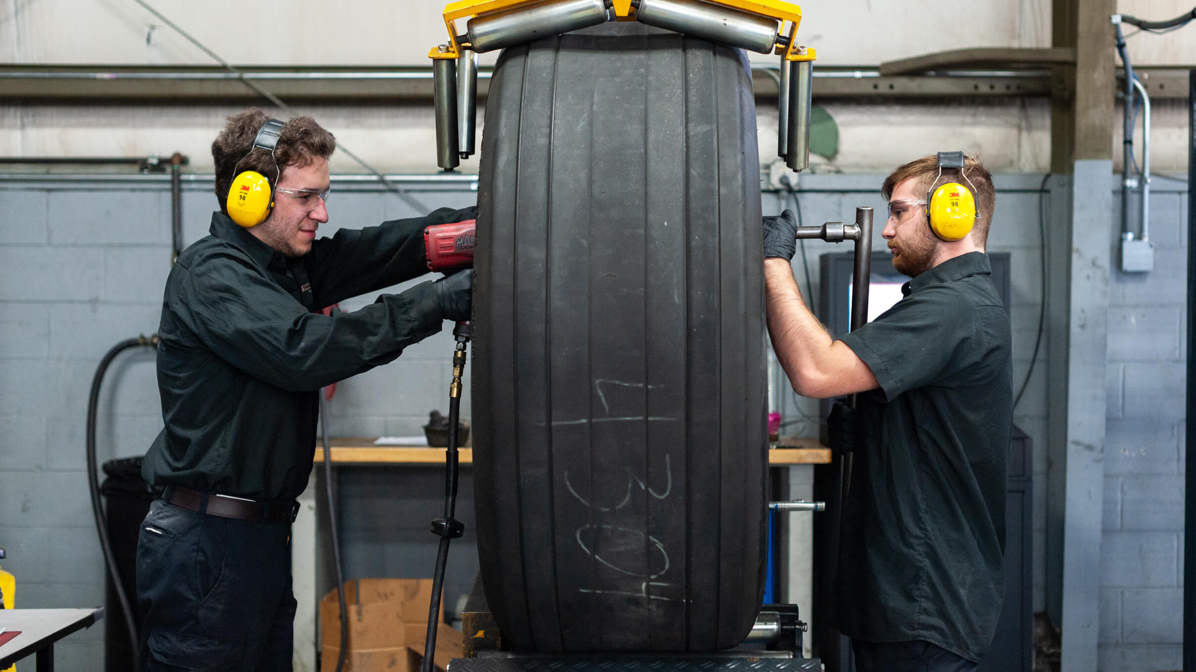 Kalitta Air Tire and Brake employees mounting a tire