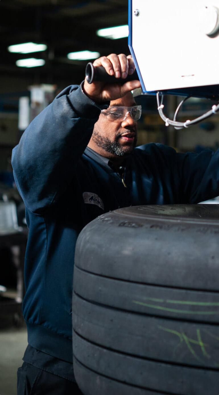 Kalitta Air employee mounting a tire
