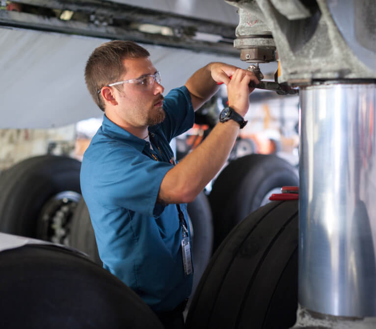 Kalitta Air employee performing maintenance on a plane