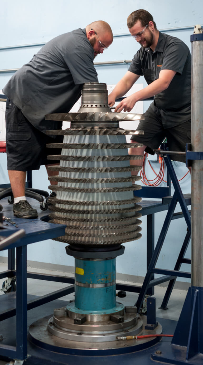 Kalitta Air Power Plant Services employees working on an engine