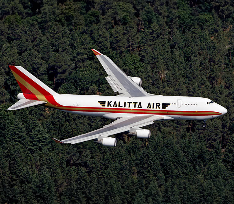 Kalitta Air employee flying over trees