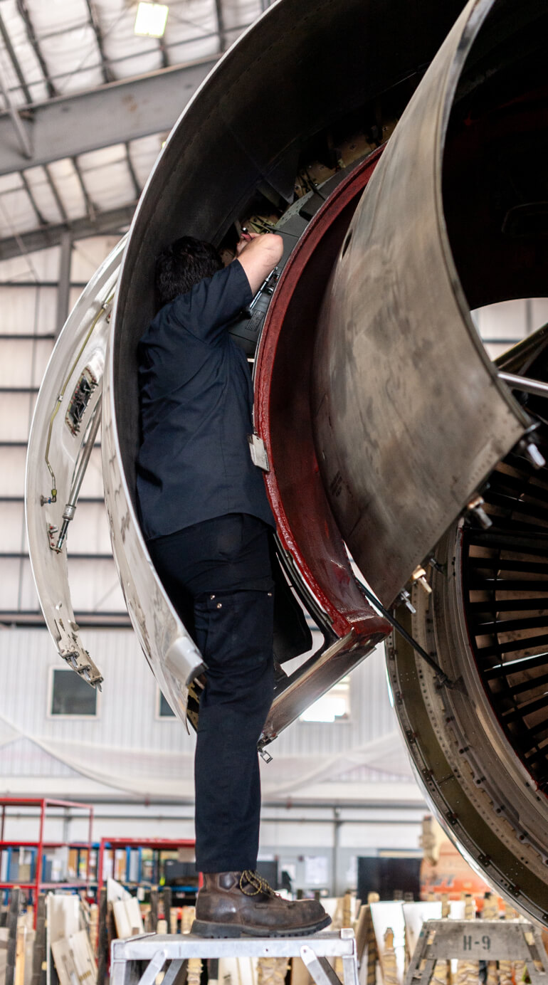Kalitta Air Power Plant Services employee working on an engine