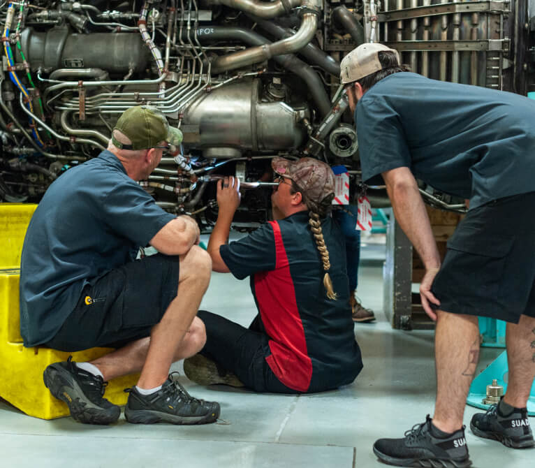 Kalitta Air employees working with a Training Center Apprentice