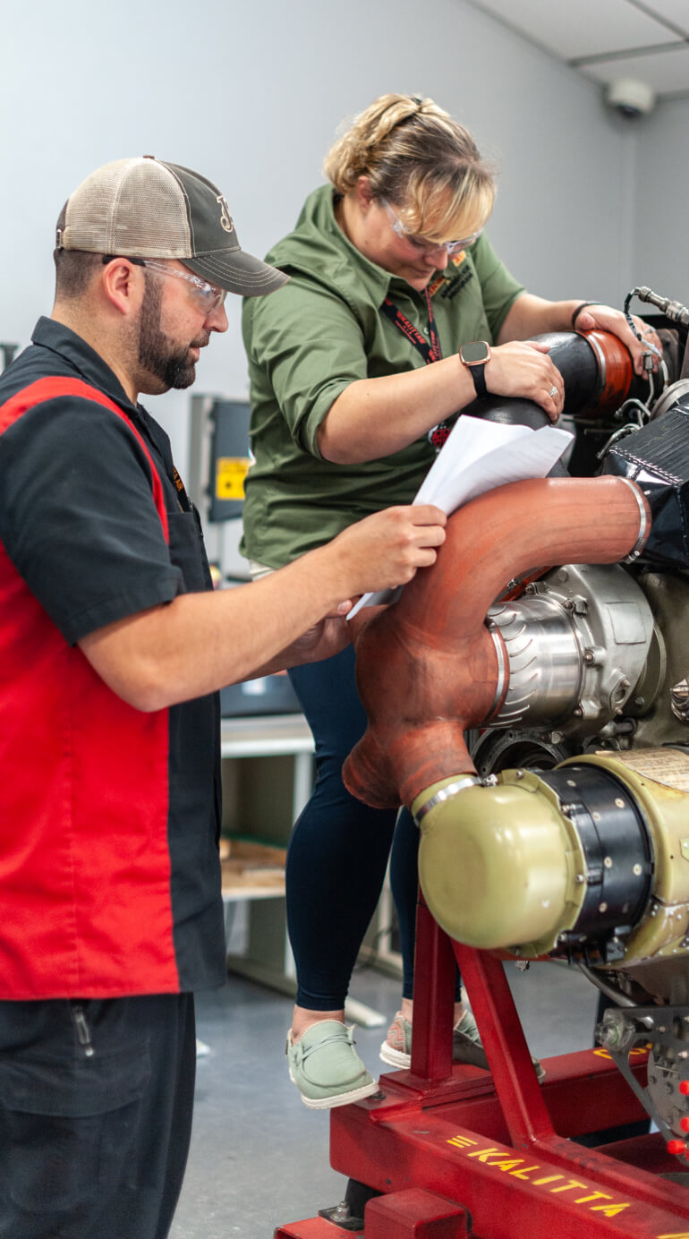 Kalitta Air Training Center employees working on engine together