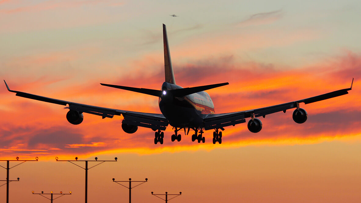 Kalitta Air plane flying towards a sunset