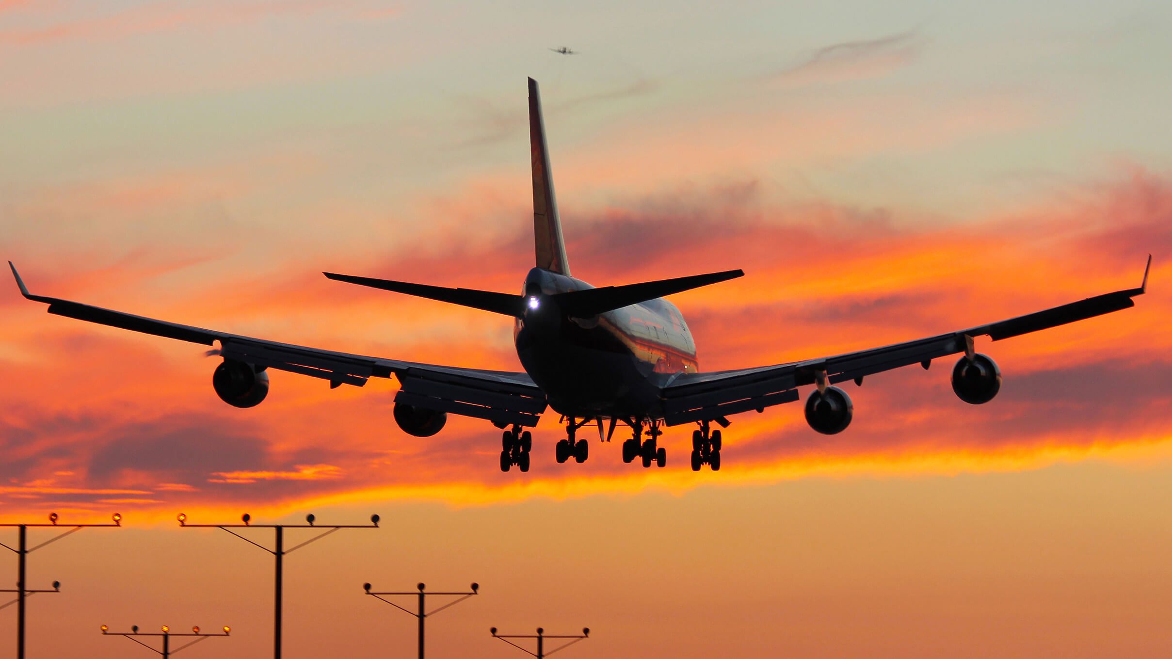 Kalitta Air plane flying towards a sunset