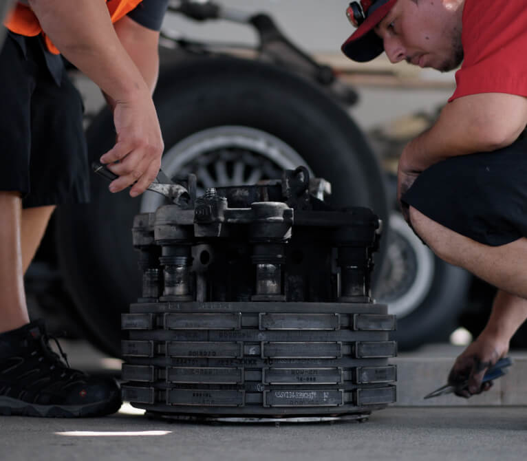 Kalitta Air maintenance technicians working on a brake assembly.